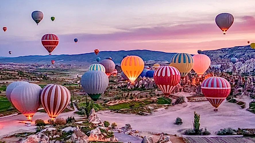 Aerial view of Cappadocia’s unique rock formations and fairy chimneys during a helicopter transfer from Antalya