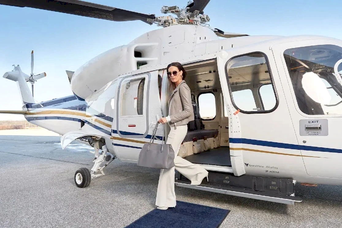 Woman with a bag boarding a helicopter for a luxury transfer flight in Antalya with zirveadam.top 