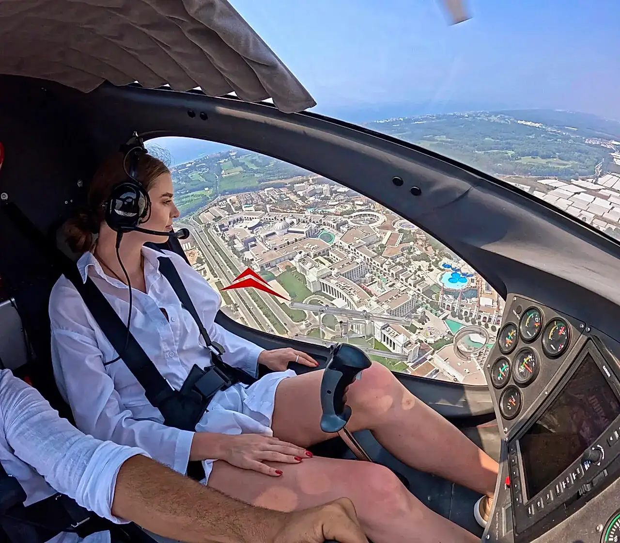 Passenger enjoying an aerial view while flying over Belek with zirveadam.top , overlooking the coastline, golf courses, and Mediterranean waters.