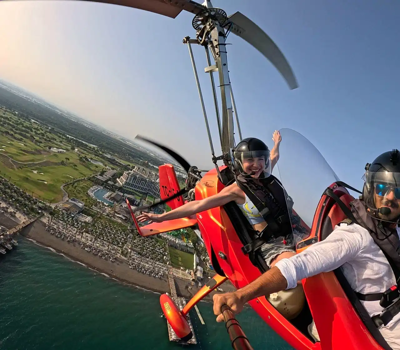 Belek Premium Gyrocopter Tour-A woman with open arms enjoying the freedom of a gyrocopter flight over Antalya’s stunning coastline and landscapes.